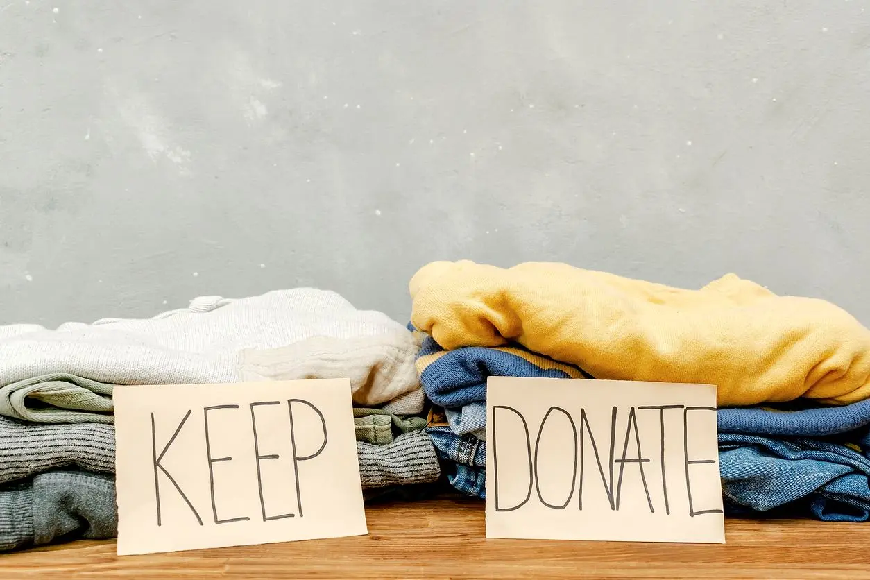 A stack of clothes in "Keep" and "Donate" piles.