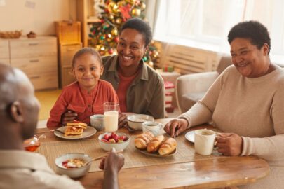 A family gathering around the table, having a holiday meal.