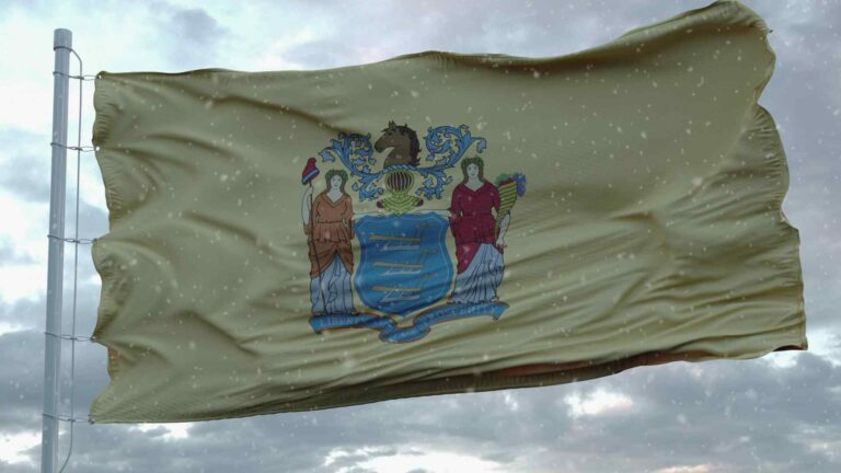 A New Jersey flag flies during winter weather