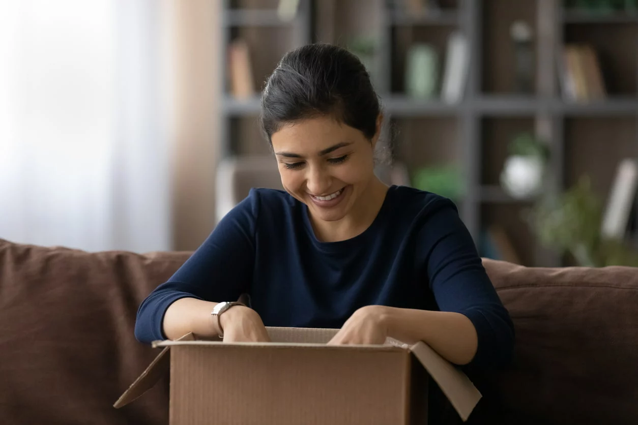 A student unpacks belongings from the box.