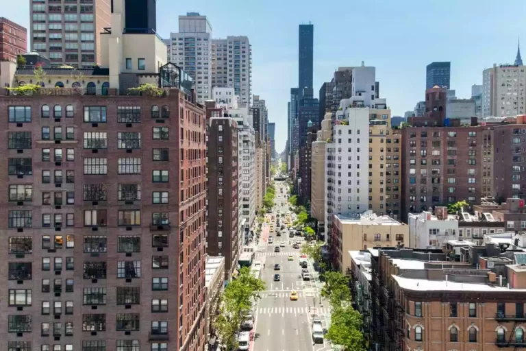 Overhead view of First Avenue with traffic driving between the buildings of Manhattan in New York City.