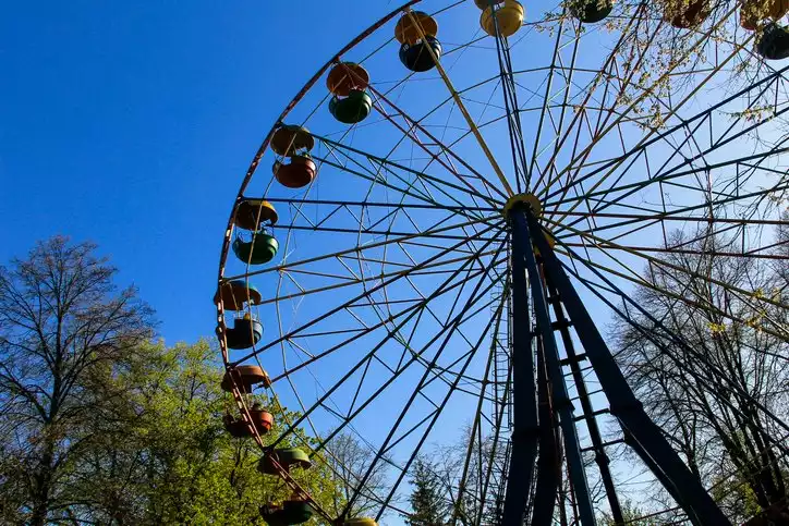 A side view of a ferris wheel at a county fair. 