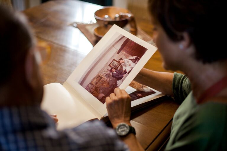 A point-of-view shot of a couple looking at a photo album.